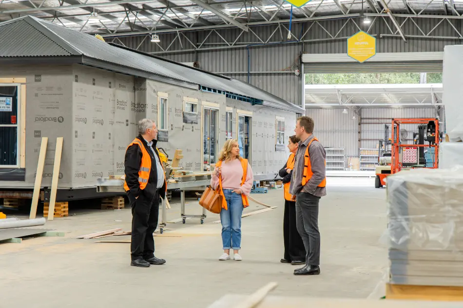 Couple comparing modular home builders during a factory tour of a modular home under construction.